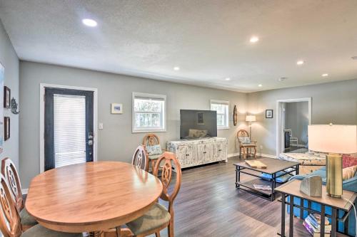 a living room with a table and a dining room at Dog-Friendly Home with Gas Grill - Walk to Rose Bay! in Port Orange