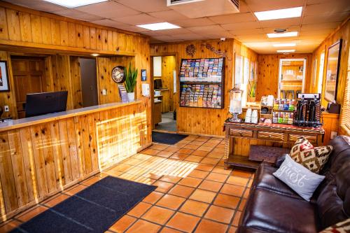 a lobby of a store with wooden walls and a counter at Big Horn Lodge in Moab