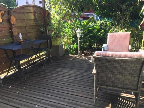 a patio with two chairs and a table and a table at T1 bis verdoyant in Cayenne