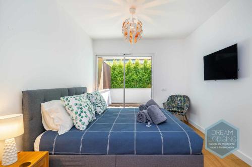 a living room with a couch and a tv at Albufeira Prime 1B - Dream Lodging in Albufeira