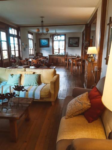 a living room with couches and a dining room at Estancia Nibepo Aike in Colonia Francisco Perito Moreno