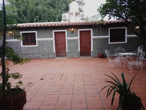 a building with red doors and a patio at Portal de las Viñas in Cafayate