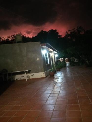 a night view of a building with a bench in front at Portal de las Viñas in Cafayate