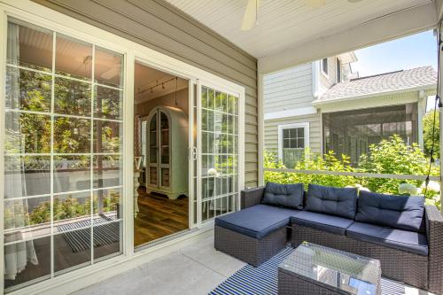 a screened porch with a blue couch on a house at Oyster Bay Villas --- 37500 Kaitlyn Dr Unit #23 in Rehoboth Beach