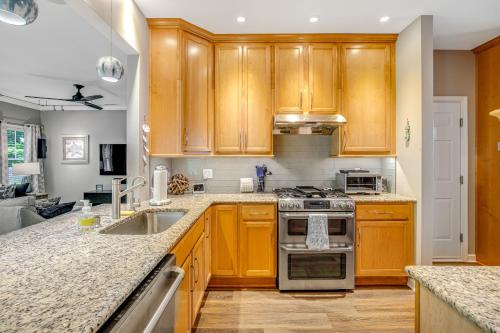 a kitchen with wooden cabinets and a sink at Oyster Bay Villas --- 37500 Kaitlyn Dr Unit #23 in Rehoboth Beach