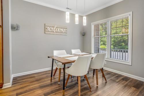 a dining room with a table and white chairs at Oyster Bay Villas --- 37500 Kaitlyn Dr Unit #23 in Rehoboth Beach