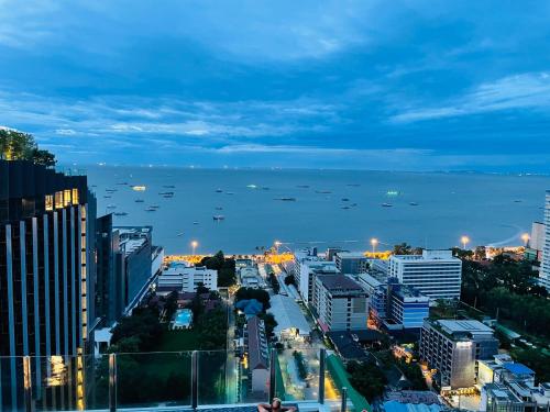 a city skyline with the ocean in the background at The base condo 142 by Pupu in Pattaya Central