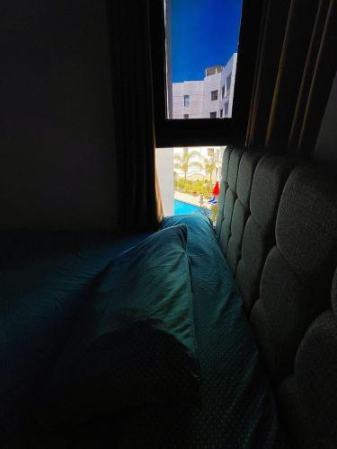 a view of a couch in a room with a window at Porto Said chalet for rent بورتوسعيد بورتو سعيد in Port Said