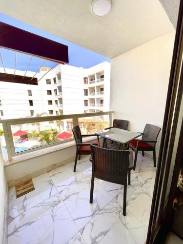 a balcony with a table and chairs and a view of a building at Porto Said chalet for rent بورتوسعيد بورتو سعيد in Port Said