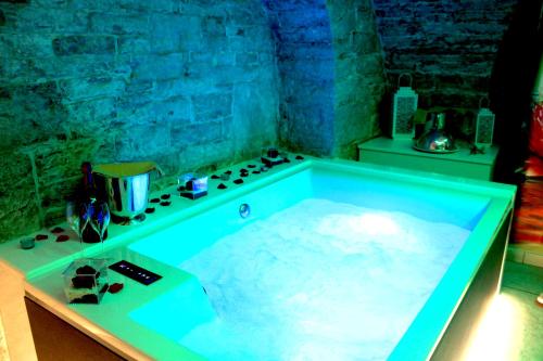 a bath tub filled with water in a room at Rubis Relais & SPA in Ruvo di Puglia