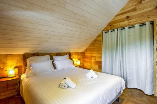 a bedroom with a bed with two towels on it at L'Atipik - Welkeys in Bénesse-Maremne