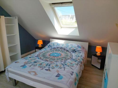 a bedroom with a bed and a window at Holiday Home in Plouhinec by Audierne Bay in Plouhinec