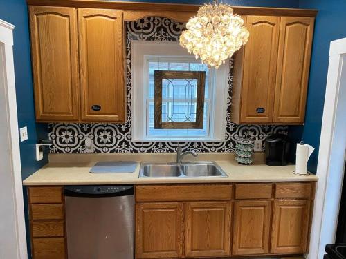 a kitchen with a sink and a mirror at Oma's House on Orange in Abilene