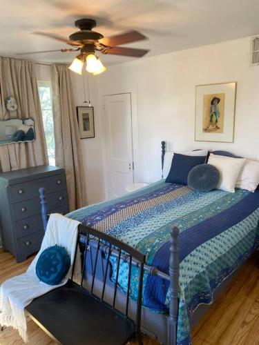 a bedroom with a bed and a ceiling fan at Oma's House on Orange in Abilene