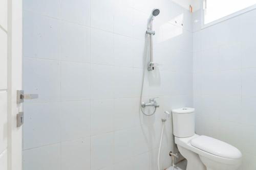 a white bathroom with a toilet and a shower at KoolKost Syariah near Alun Alun Tasikmalaya (Minimum Stay 30 Nights) in Tasikmalaya