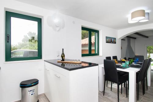 a kitchen and dining room with a table and chairs at Villa Mungo in Starigrad-Paklenica