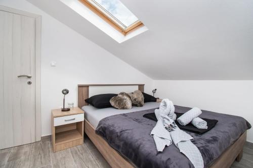 a bedroom with a bed with towels on it at Villa Mungo in Starigrad-Paklenica