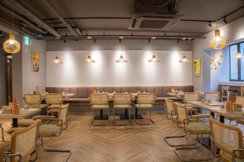 a restaurant with tables and chairs in a room at Hotel Foret The Spa in Busan