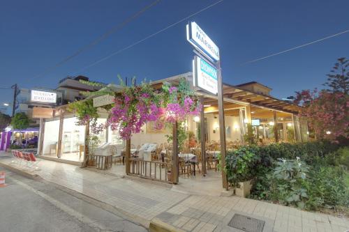 a restaurant with tables and chairs on a street at Marirena Hotel in Amoudara Herakliou