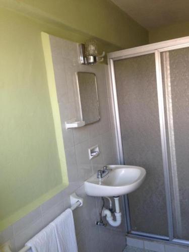 a bathroom with a sink and a shower at Hotel Lorena in Los Mochis
