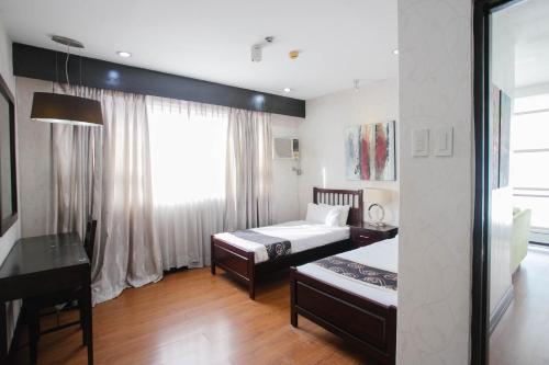Ένα ή περισσότερα κρεβάτια σε δωμάτιο στο Diamond Suites and Residences