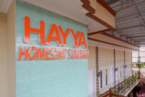 a large sign on the side of a building at RedDoorz Syariah near Terminal Mendolo Wonosobo 2 in Ngasinan
