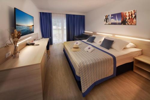 a hotel room with a large bed in a room at Villa Cedra - Hotel & Resort Adria Ankaran in Ankaran