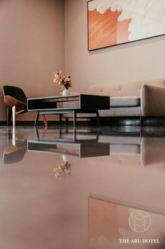 a living room with a couch and a coffee table at The Aru Hotel at Aru Suites in Kota Kinabalu
