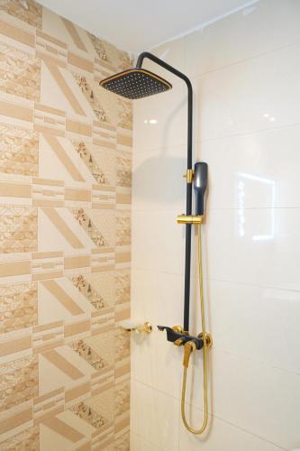 a shower with a glass door in a bathroom at NuvaHotel in Islamabad