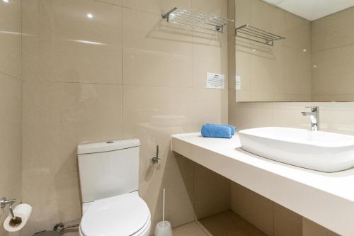 a bathroom with a white toilet and a sink at Adelais Bay Hotel in Protaras