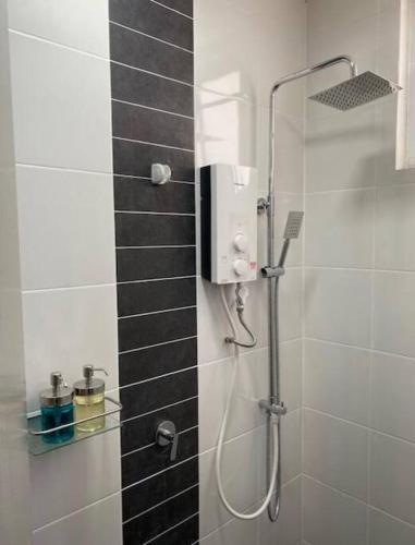 a shower in a bathroom with a glass door at Skynature@Mesahill-Nature view-Poolview-Fast Wifi in Nilai
