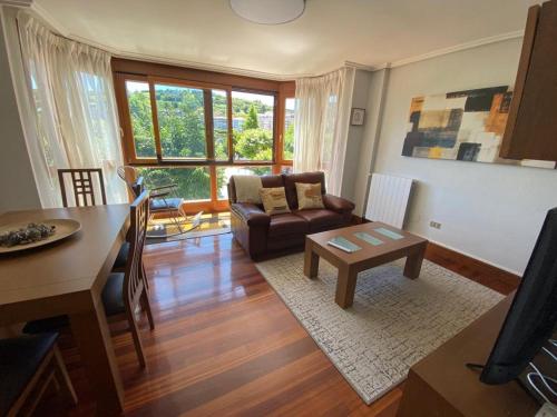 a living room with a couch and a table at ARTZA ETXIE LA CASA EBI01934 in Bermeo