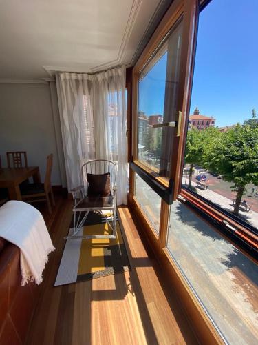 a room with a window with a chair and a view at ARTZA ETXIE LA CASA EBI01934 in Bermeo