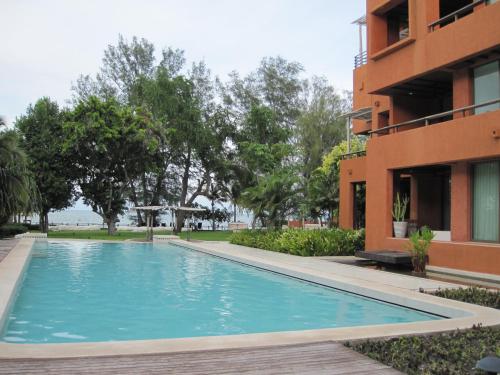 a swimming pool in front of a building at Las Tortugas Apartment Unit C101 in Khao Tao