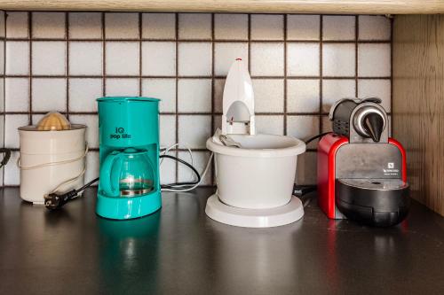 a kitchen counter with a blender and other appliances at Casa Nebari Seaside Retreats - Fully Equipped, Ideal Spot in Petalidhion