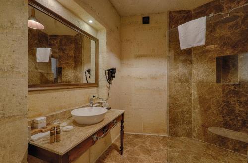 a bathroom with a sink and a shower at Solem Cave Suites in Urgup