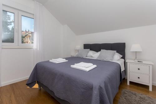 - une chambre blanche avec un lit et 2 serviettes dans l'établissement Apartment Gloria, à Dubrovnik