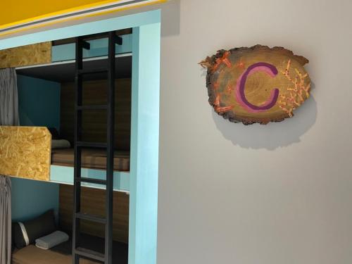 a donut hanging on a wall next to a bunk bed at Good hostel 好棧 Green Island in Green Island