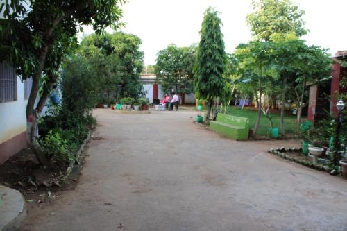 an empty road in a park with trees at "Priyadarshi Villa" Free pickup in ac car from Jasidih Railway station or Deoghar Airport in Deoghar