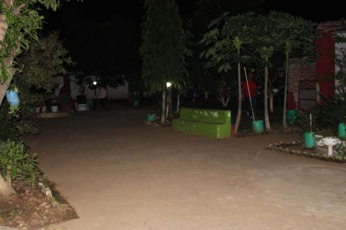a parking lot at night with trees and plants at "Priyadarshi Villa" Free pickup in ac car from Jasidih Railway station or Deoghar Airport in Deoghar