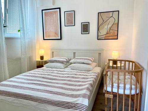 a bedroom with a bed and three pictures on the wall at P&P APARTMÁNY Bojnice in Bojnice