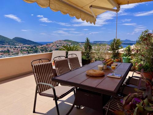 a table and chairs on a balcony with a view at Apartment Lana in Dubrovnik