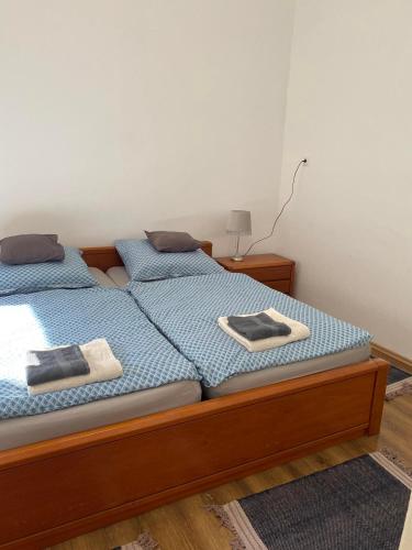 two beds in a bedroom with towels on them at Bartók Szálló in Baja
