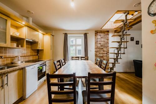 a kitchen with a long wooden table and chairs at Na Želivce chalupa Marie in Želiv