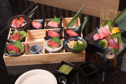 a group of sushi dishes on a table at 12 The Residence Hotel at Don Mueang Airport in Bangkok