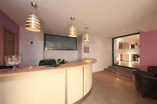 an office with a bar with chairs and a window at Logis Hotel Cara Sol in Elne