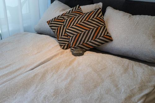 a bed with two pillows on top of it at Alte Teestube Alte Teestube 57 in Norderney