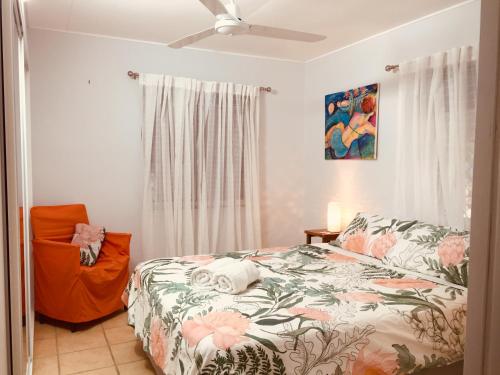 a bedroom with a bed and a ceiling fan at Sandy toes in Yeppoon