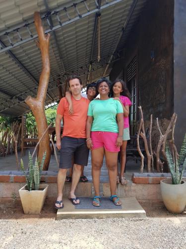a group of people standing in front of a house at Ceylon Resort in Wilpattu