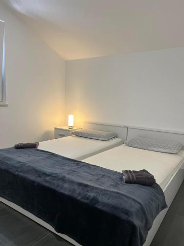 a bedroom with two beds with a blue blanket at Apartment Vodice - Lovric in Vodice